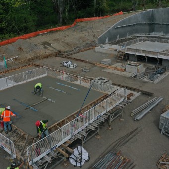placing concrete at one of the seismic isolation slabs